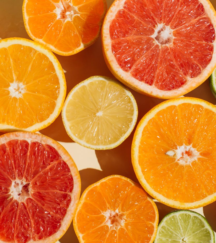 Pattern of slices citrus-fruit of Lemons, oranges, grapefruit, lime on beige background. Healthy food, diet and detox concept. Flat lay, top view
